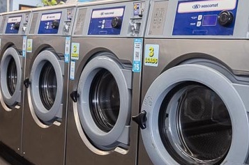 Row of triple loader washing machines at Laundry on 8th.